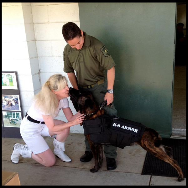 Stanislaus County Sheriff K-9 Sam gives kisses to Suzanne Saunders for his K9 Armor bulletproof vest. Photo by Karen Introcaso